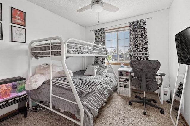 bedroom with ceiling fan, carpet flooring, and a textured ceiling