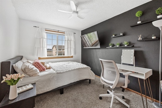 carpeted bedroom featuring a ceiling fan and a textured ceiling