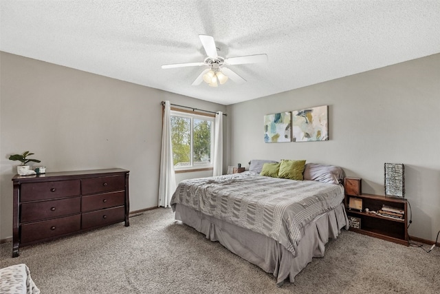 bedroom with baseboards, carpet, a textured ceiling, and a ceiling fan