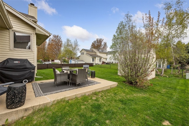 view of yard featuring a fenced backyard, a patio, and a residential view
