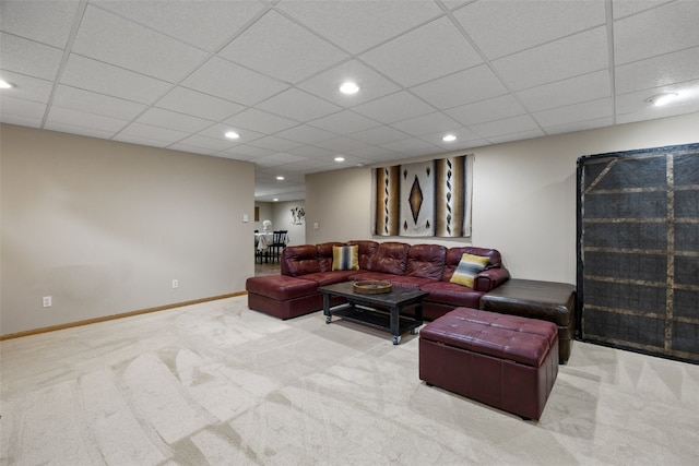 carpeted living area with recessed lighting and a drop ceiling