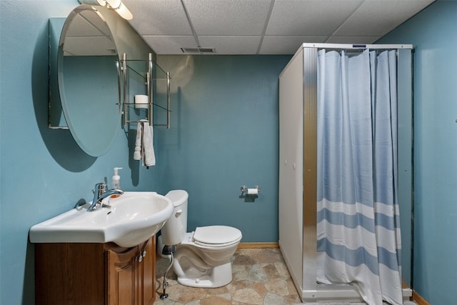 bathroom featuring visible vents, vanity, toilet, a shower stall, and stone finish flooring