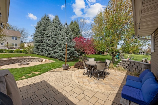 view of patio featuring outdoor dining space and an outdoor fire pit