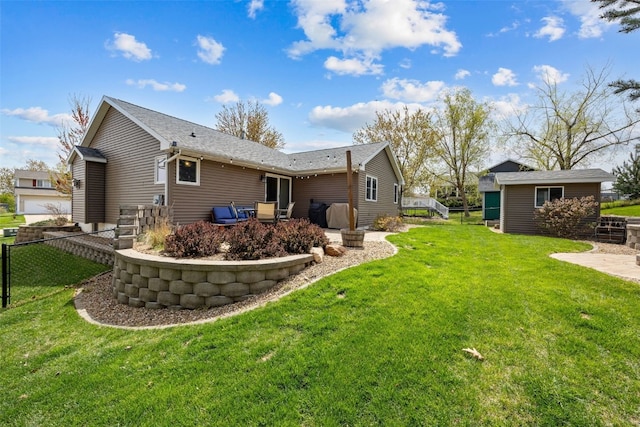 rear view of property with fence, a patio, and a yard