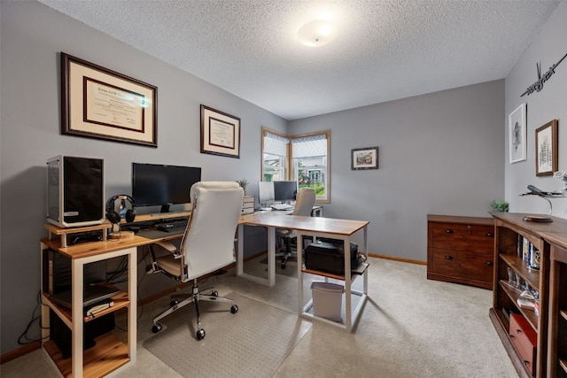carpeted home office featuring baseboards and a textured ceiling