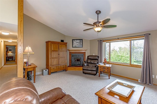 living room featuring carpet floors, a ceiling fan, baseboards, and lofted ceiling
