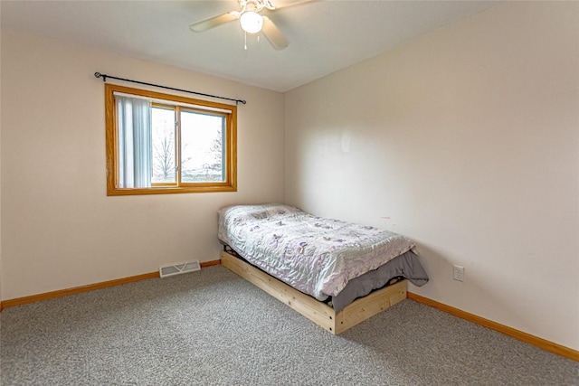 carpeted bedroom featuring visible vents, a ceiling fan, and baseboards