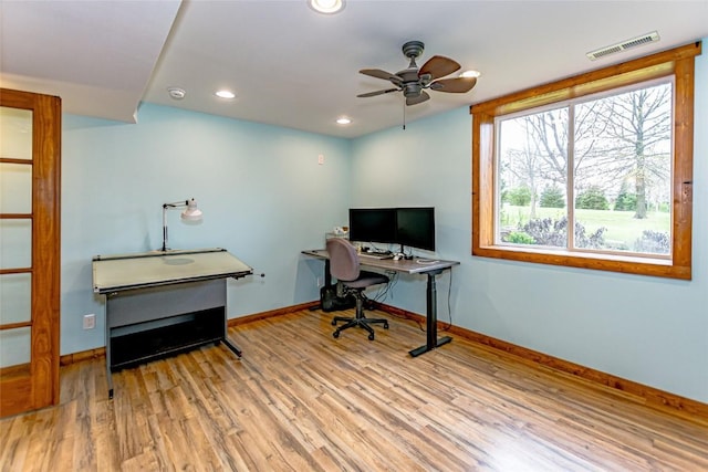 home office featuring a ceiling fan, baseboards, visible vents, and wood finished floors