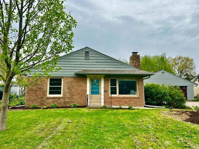 2105 Muscatine Ave, Iowa City, IA 52240 - view of front of home featuring a chimney, a front lawn, and brick siding