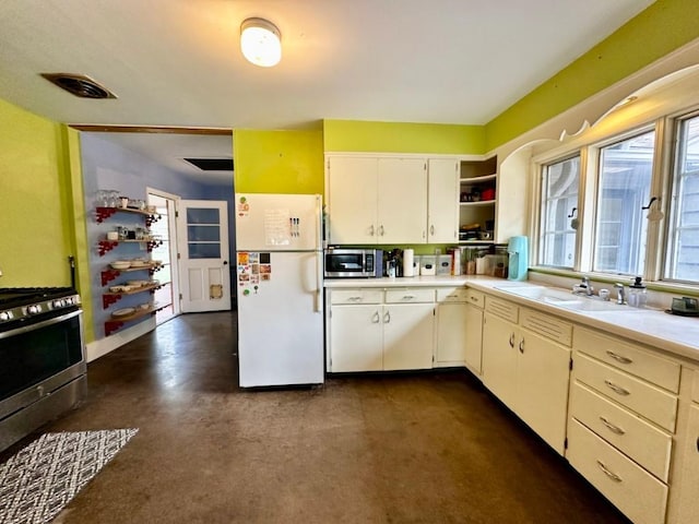 2105 Muscatine Ave, Iowa City, IA 52240 - kitchen featuring open shelves, appliances with stainless steel finishes, a sink, light countertops, and visible vents