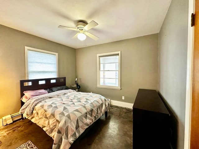 2105 Muscatine Ave, Iowa City, IA 52240 - bedroom featuring baseboards, ceiling fan, baseboard heating, and dark colored carpet