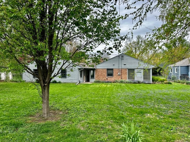2105 Muscatine Ave, Iowa City, IA 52240 - back of property with fence, a yard, and brick siding