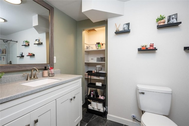 bathroom featuring baseboards, vanity, toilet, and marble finish floor