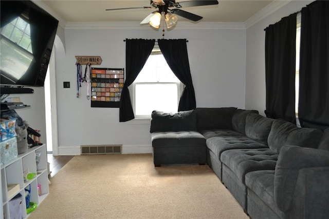 855 Center Pt NE, Cedar Rapids, IA 52402 - carpeted living room featuring crown molding and a ceiling fan