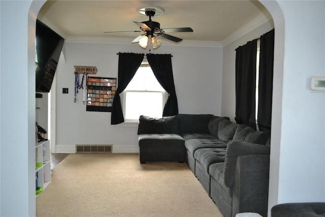 855 Center Pt NE, Cedar Rapids, IA 52402 - carpeted living area with arched walkways, ceiling fan, and crown molding