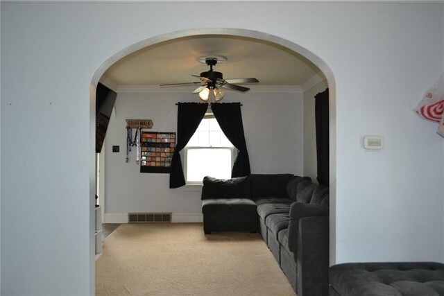 855 Center Pt NE, Cedar Rapids, IA 52402 - living area featuring a ceiling fan, arched walkways, ornamental molding, and carpet flooring