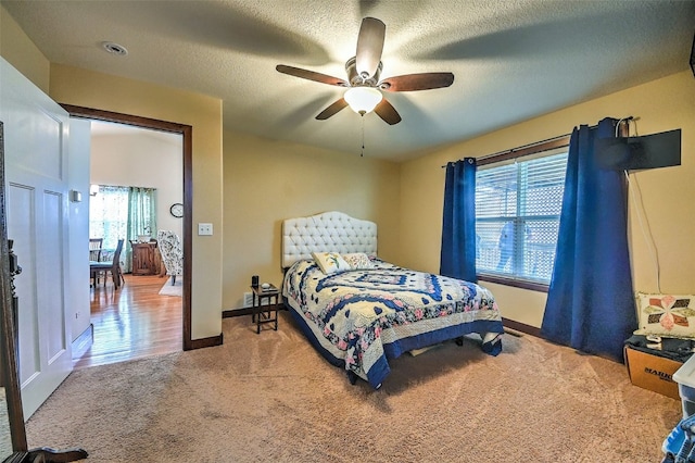 bedroom with carpet floors, baseboards, and multiple windows