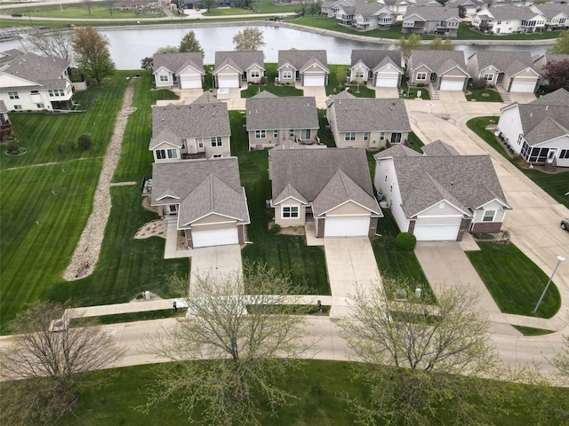birds eye view of property with a residential view and a water view