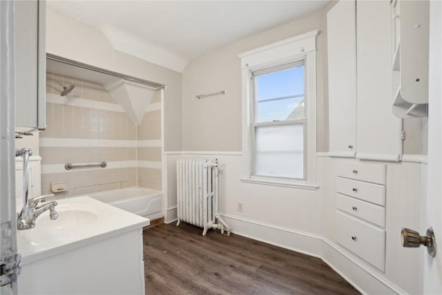 bathroom featuring wainscoting, wood finished floors, radiator, and vanity