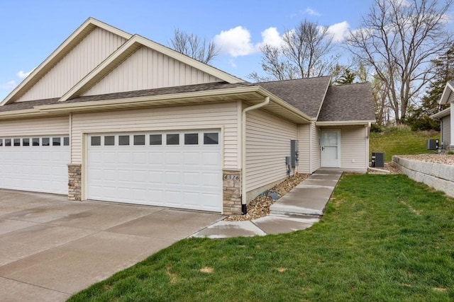 view of front of property with a garage, a front lawn, board and batten siding, and concrete driveway