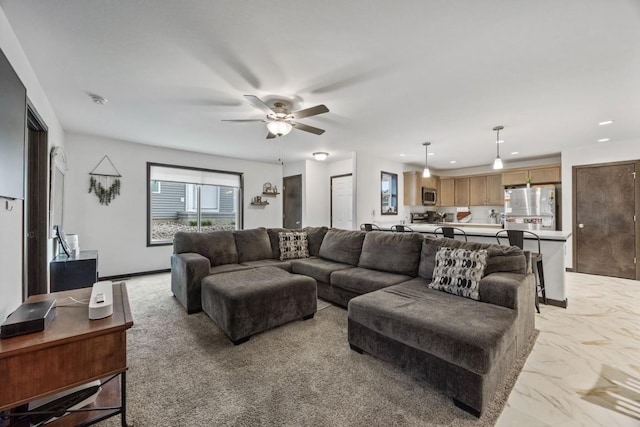 living room featuring a ceiling fan, recessed lighting, and marble finish floor
