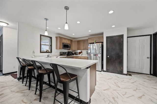 kitchen with a sink, stainless steel appliances, a peninsula, and marble finish floor