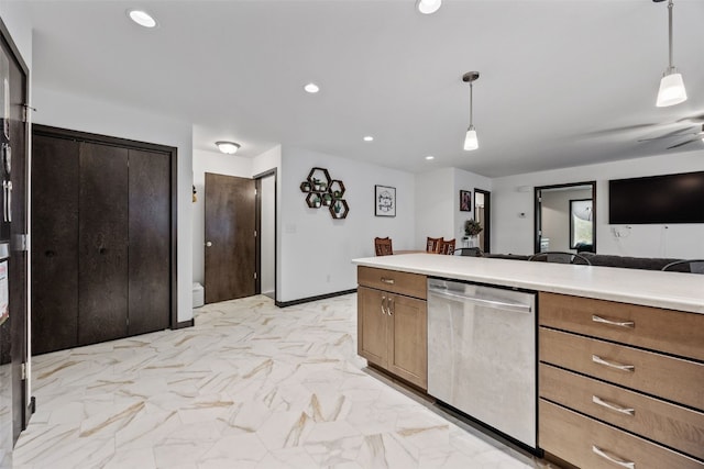 kitchen featuring light countertops, stainless steel dishwasher, decorative light fixtures, and open floor plan