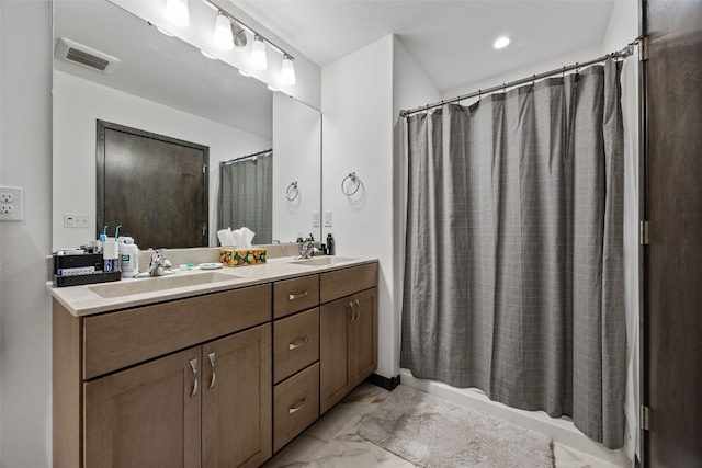 bathroom with double vanity, visible vents, a sink, and marble finish floor