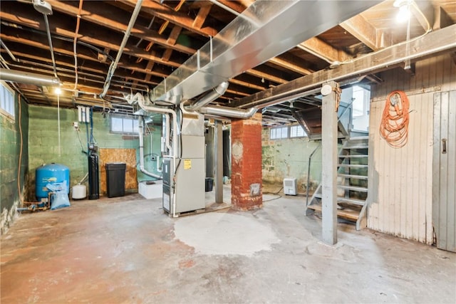 below grade area featuring heating unit and stairway