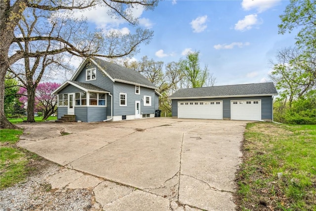 exterior space featuring entry steps, an outbuilding, and a detached garage