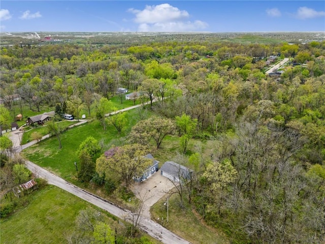 bird's eye view featuring a wooded view
