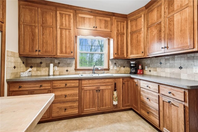 kitchen featuring a sink and brown cabinets