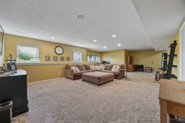 carpeted living area featuring baseboards, recessed lighting, and a textured ceiling