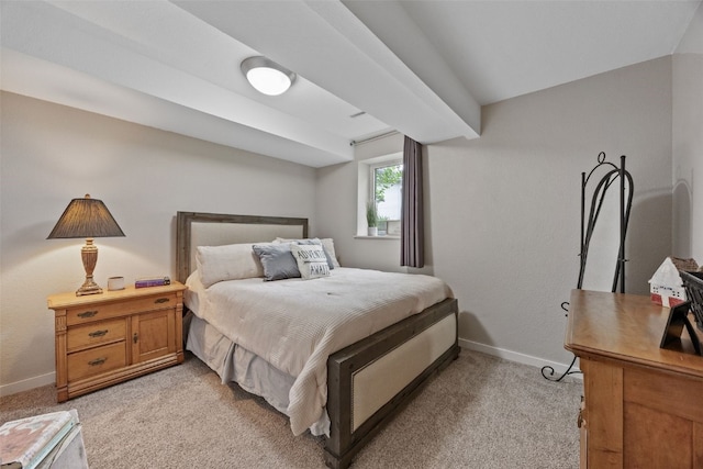 bedroom featuring baseboards and light colored carpet