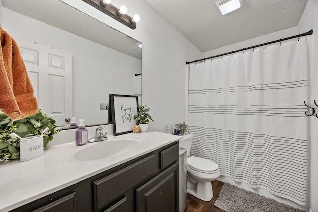 bathroom featuring vanity, toilet, a shower with shower curtain, wood finished floors, and visible vents