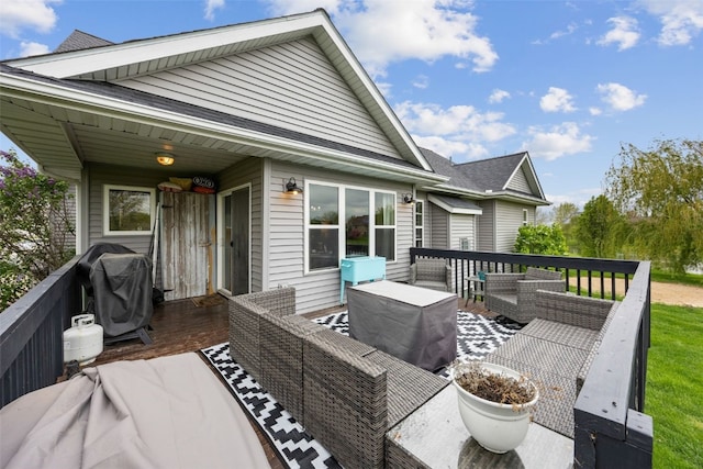 wooden deck with grilling area and outdoor lounge area