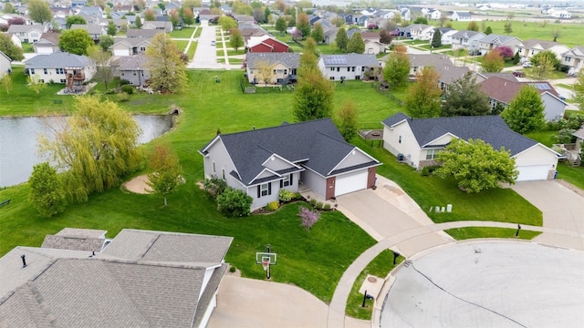 birds eye view of property with a residential view and a water view