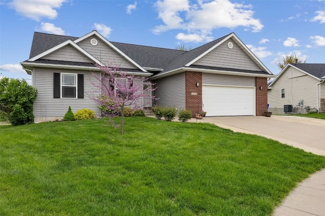 view of front of property featuring a garage, a front lawn, roof with shingles, brick siding, and driveway