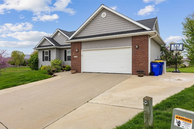 single story home with an attached garage, concrete driveway, a front yard, and brick siding