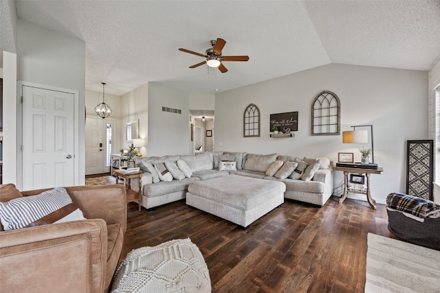living room featuring a textured ceiling, visible vents, dark wood-style floors, and ceiling fan with notable chandelier