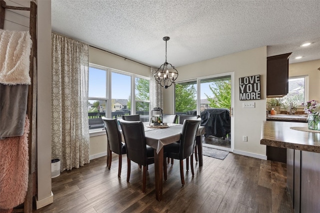 dining area with baseboards, recessed lighting, a textured ceiling, a chandelier, and dark wood finished floors