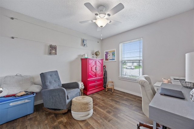 office area featuring a textured ceiling, baseboards, a ceiling fan, and wood finished floors