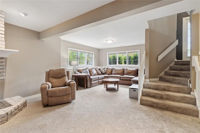 carpeted living area with stairway