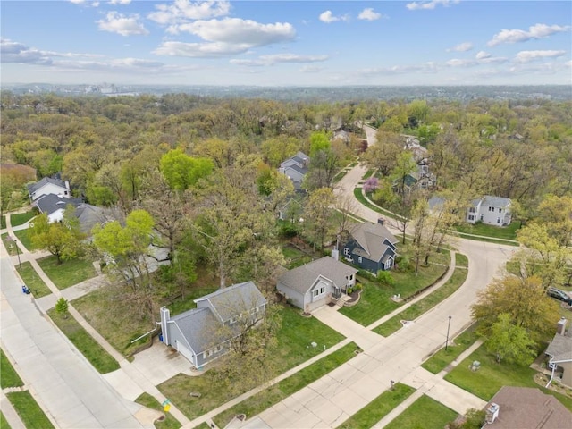 birds eye view of property featuring a residential view and a wooded view