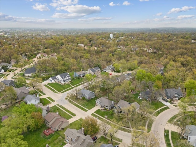aerial view with a wooded view and a residential view