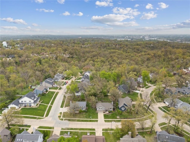 birds eye view of property featuring a forest view and a residential view