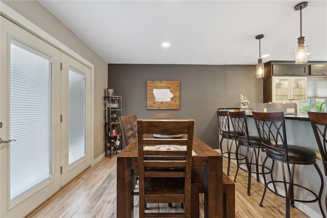 dining space with baseboards, recessed lighting, and light wood-style flooring