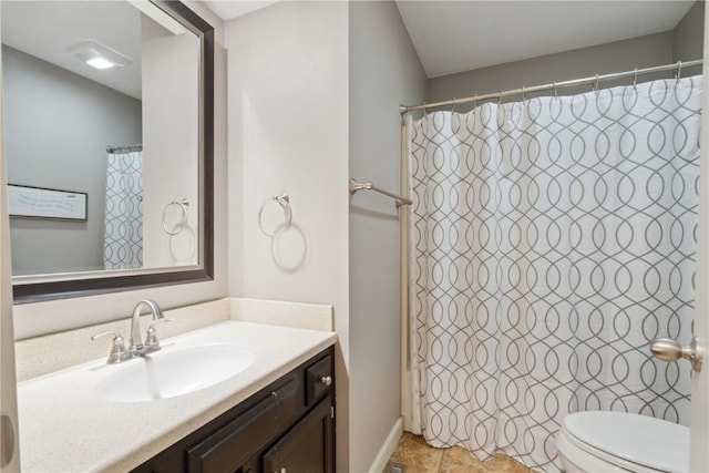 full bathroom with vanity, shower / tub combo, and toilet