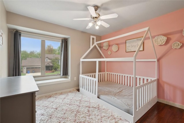 bedroom with baseboards, ceiling fan, and wood finished floors