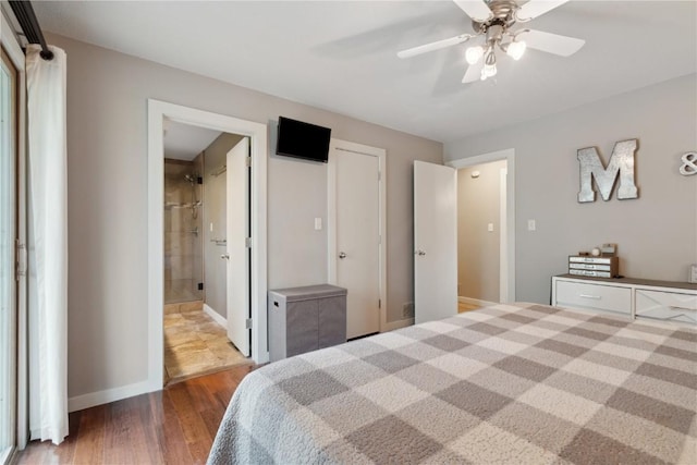 bedroom with ceiling fan, wood finished floors, and connected bathroom